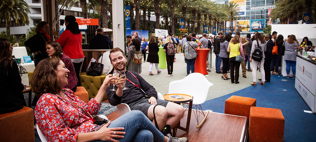 Two IPW attendees enjoying wine at the California Plaza